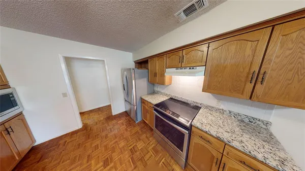 a view of kitchen and wooden floor