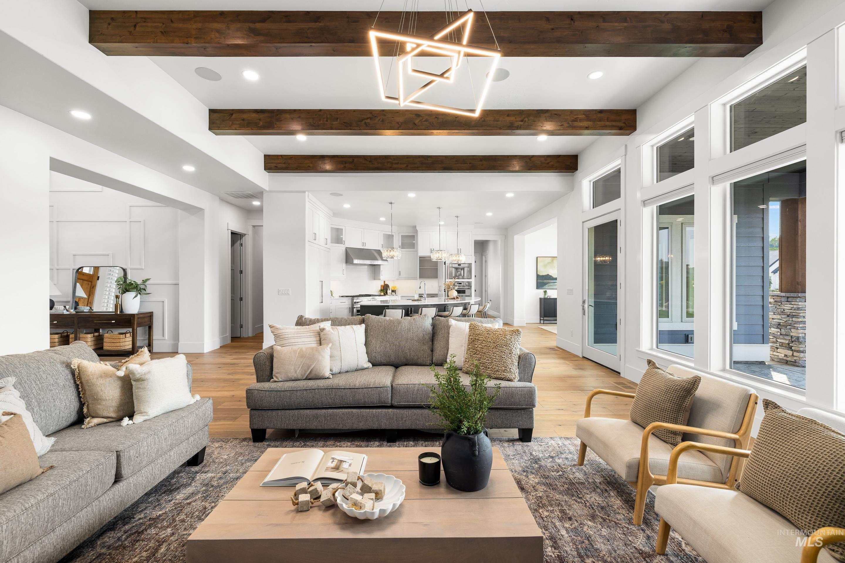 2379 South Mallard Wing Way Eagle, ID 83616 - Photo 11 of 48 Living room featuring a chandelier, wood finished floors, beamed ceiling, and recessed lighting