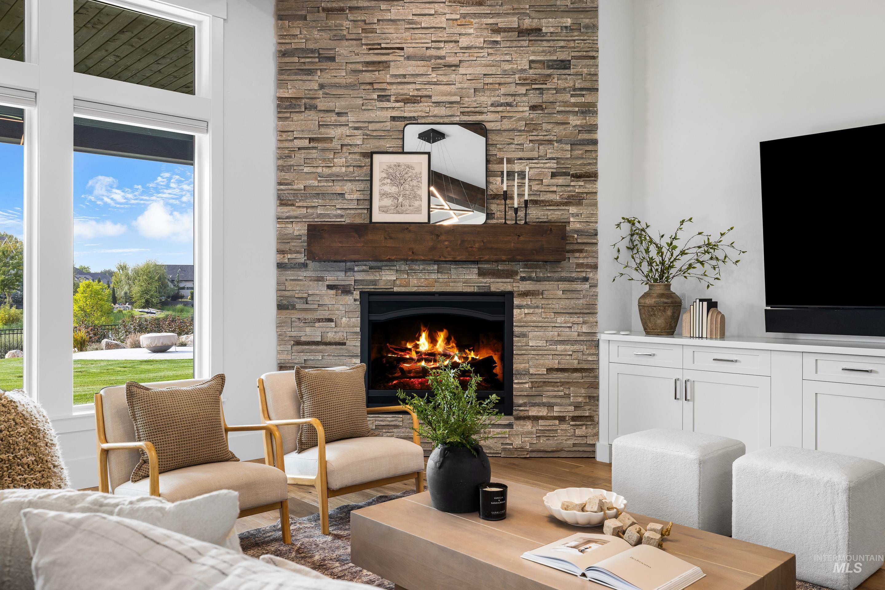 2379 South Mallard Wing Way Eagle, ID 83616 - Photo 12 of 48 Living room featuring wood finished floors and a fireplace