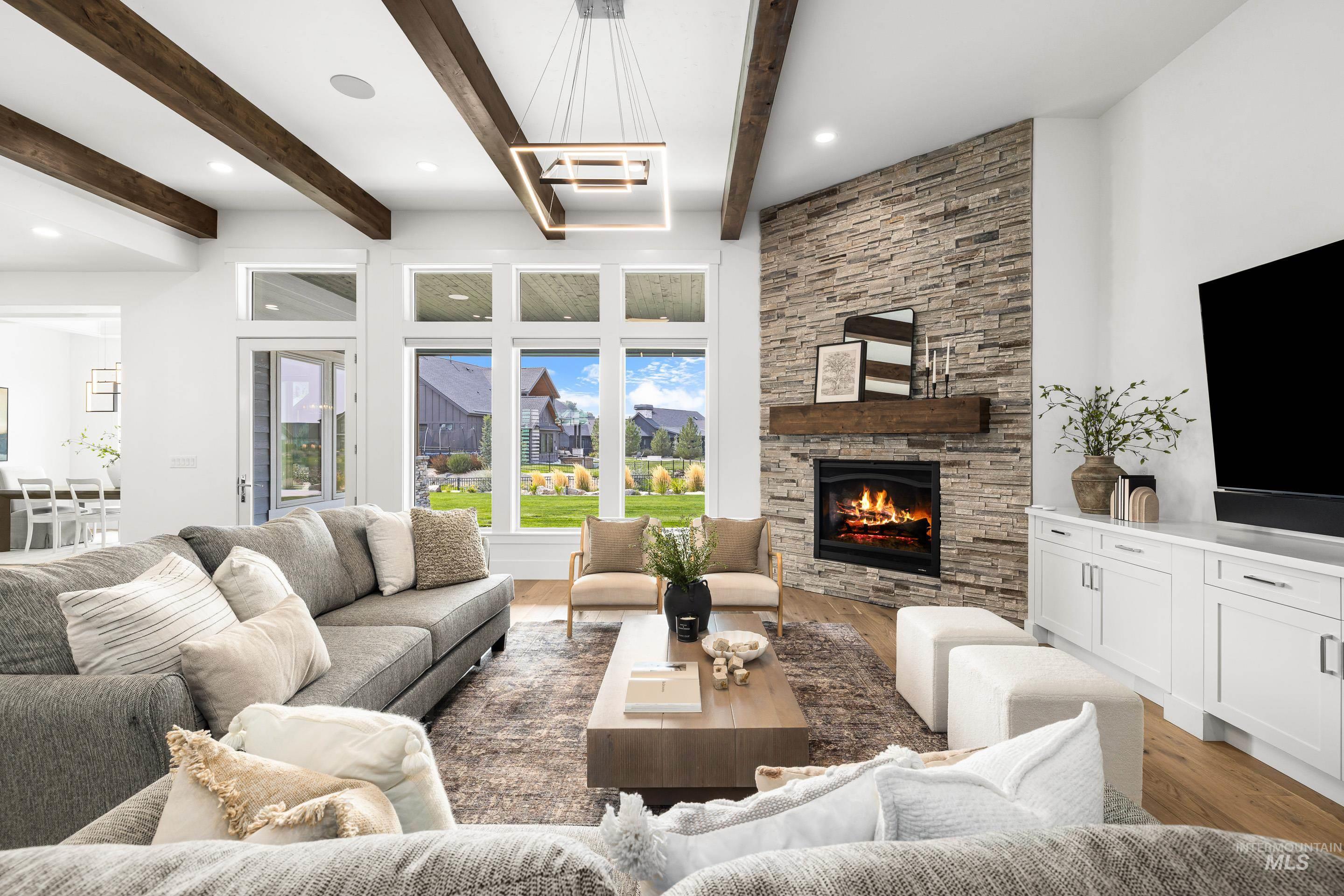 2379 South Mallard Wing Way Eagle, ID 83616 - Photo 10 of 48 Living area with light wood finished floors, beam ceiling, a fireplace, and recessed lighting