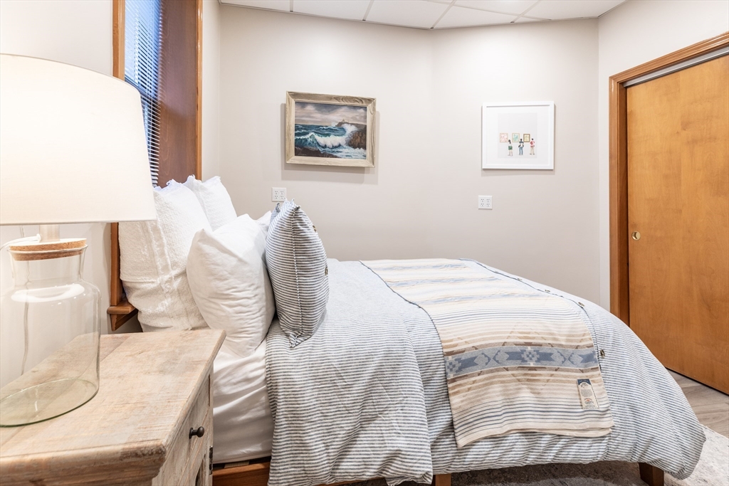 265 North Street, Unit A Boston, MA 02113 - Photo 11 of 17 a bedroom with a bed and a painting on the wall