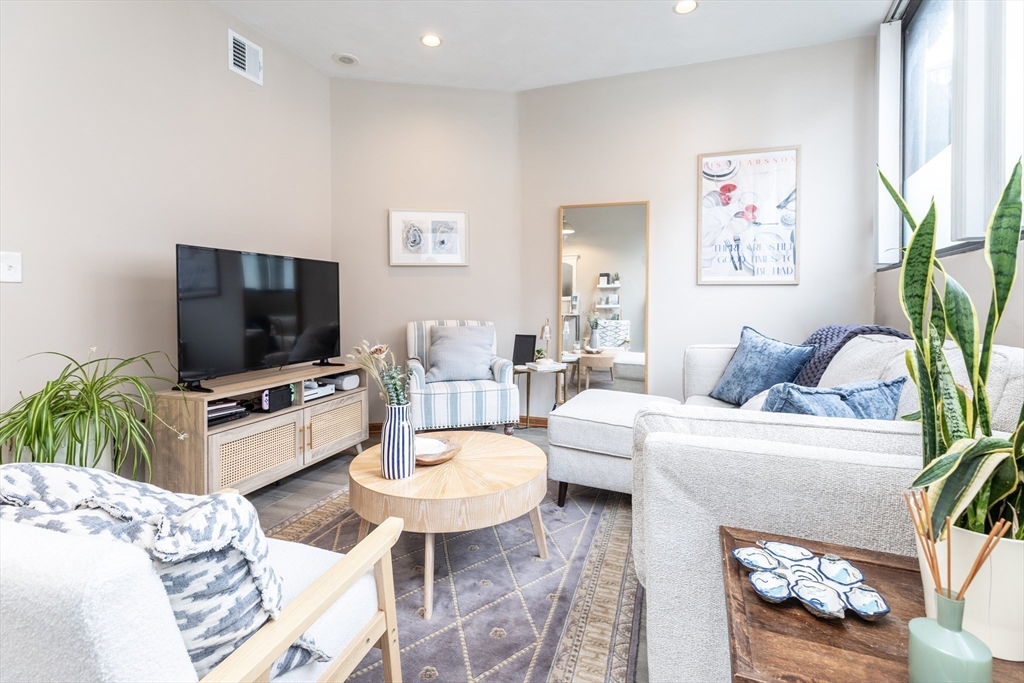 265 North Street, Unit A Boston, MA 02113 - Photo 2 of 17 a living room with furniture and a flat screen tv