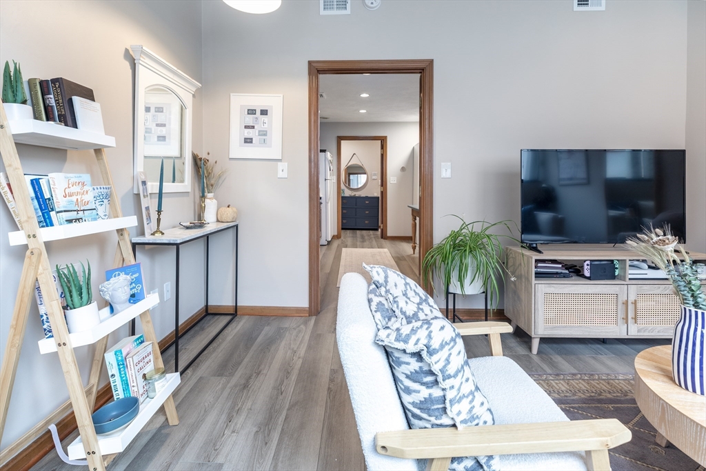 265 North Street, Unit A Boston, MA 02113 - Photo 4 of 17 a living room with furniture and a flat screen tv