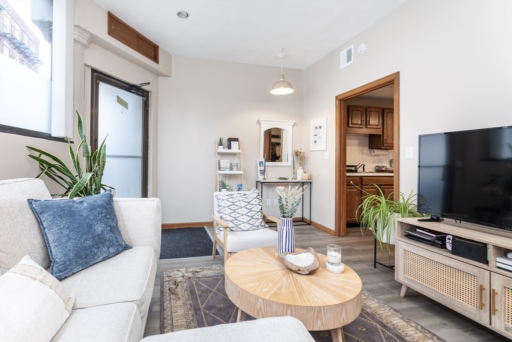 265 North Street, Unit A Boston, MA 02113 - Photo 5 of 17 a living room with furniture and a flat screen tv