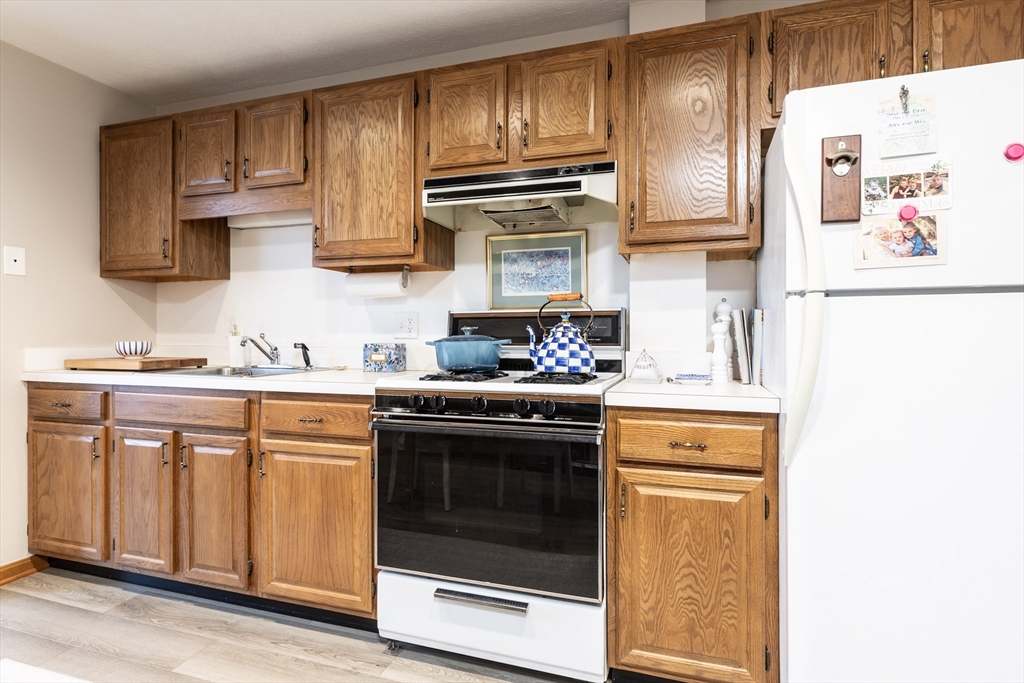 265 North Street, Unit A Boston, MA 02113 - Photo 6 of 17 a kitchen with stainless steel appliances granite countertop a stove and a microwave