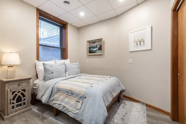 a bedroom with bed and a window