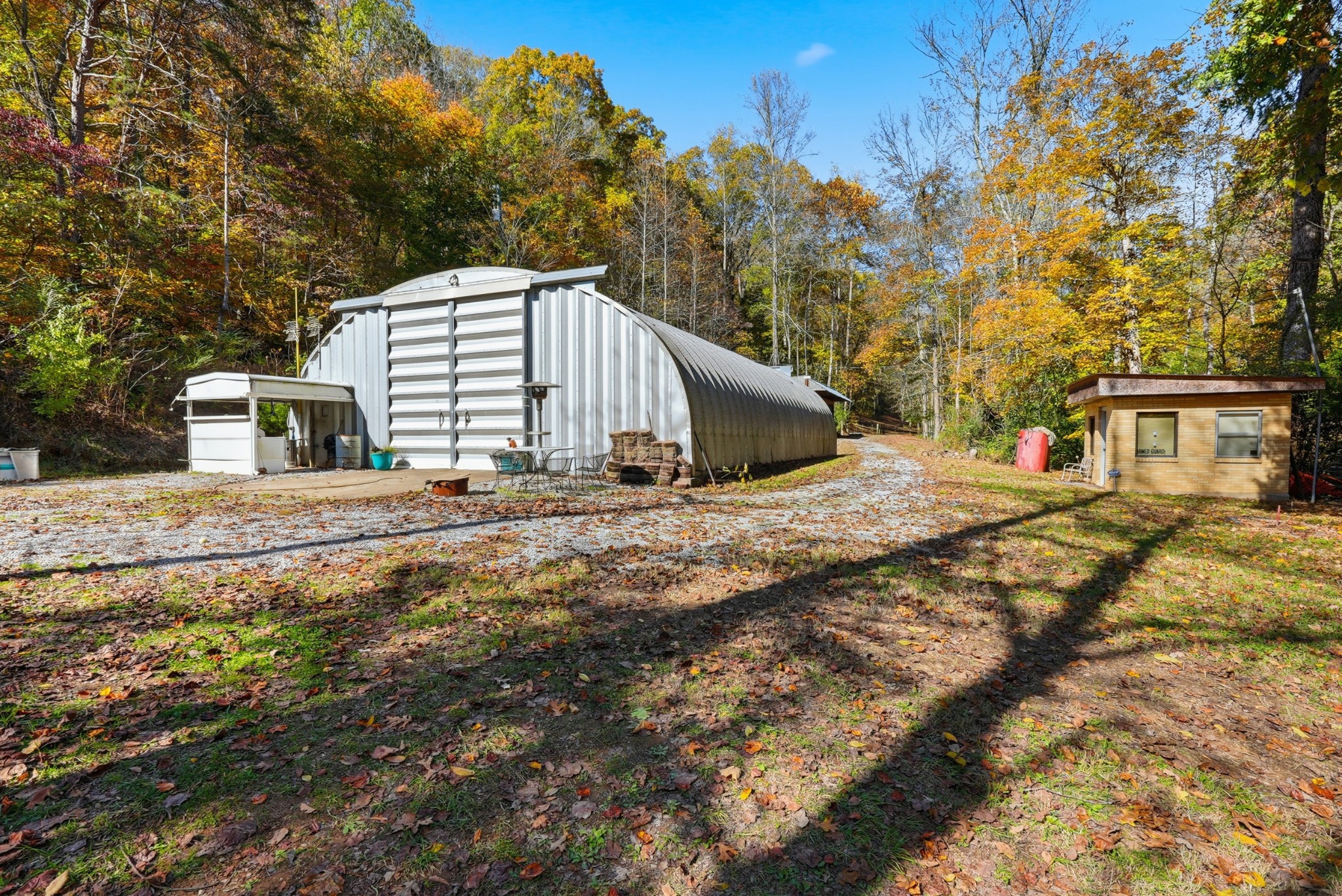 4300 Bull Run Road Ashland City, TN 37015 - Photo 58 of 61 a backyard of a house with large trees and outdoor seating