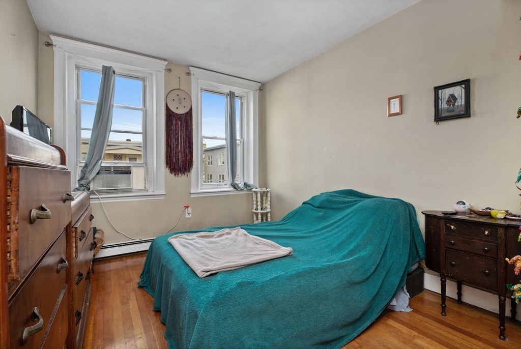 32 Ransom Road, Unit 10 Boston, MA 02135 - Photo 3 of 12 a living room with a bed furniture and a window