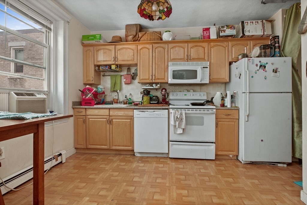 32 Ransom Road, Unit 10 Boston, MA 02135 - Photo 6 of 12 a utility room with cabinets washer and dryer