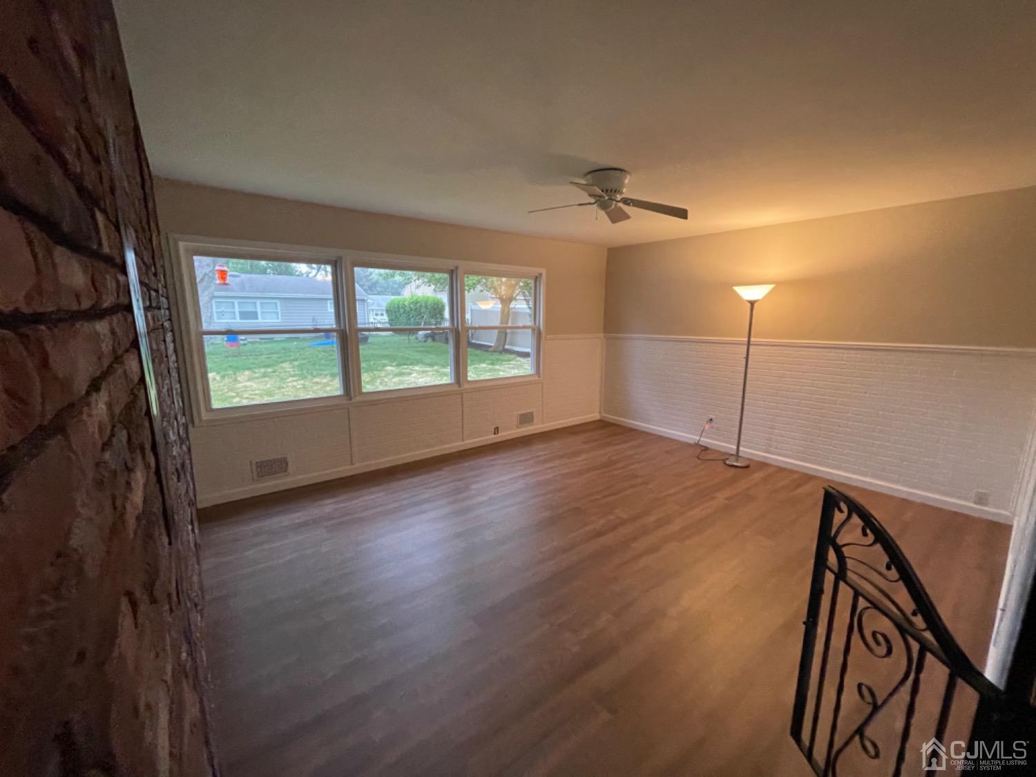 122 Princeton Road Old Bridge, NJ 08859 - Photo 8 of 40 wooden floor in an empty room with a window