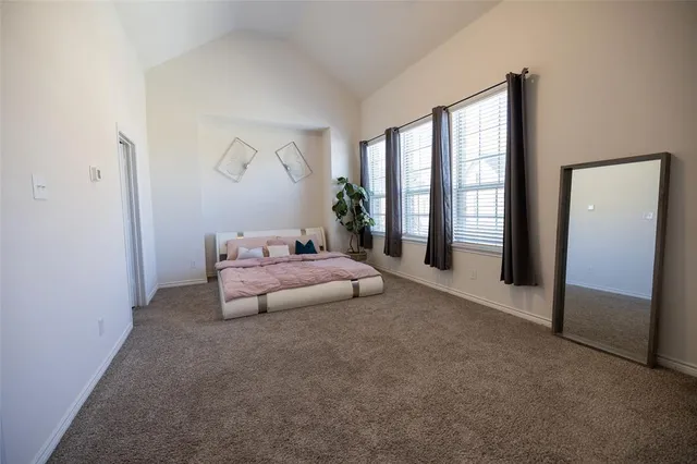 a bedroom with a bed and a large window