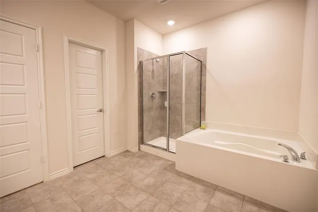 a bathroom with a bathtub and a shower