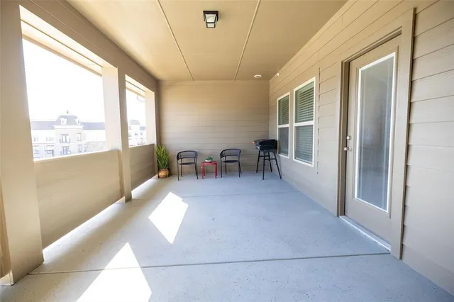 a dining room with furniture and a floor to ceiling window