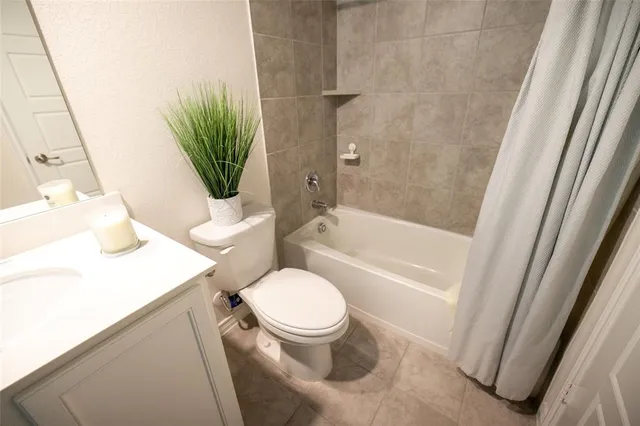 a white toilet sitting next to a bath tub