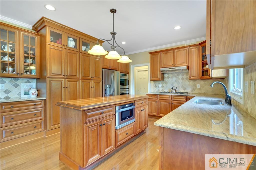 21 Rolin's Mill Road Flemington, NJ 08822 - Photo 12 of 25 a kitchen with stainless steel appliances granite countertop a sink a stove and a wooden floors