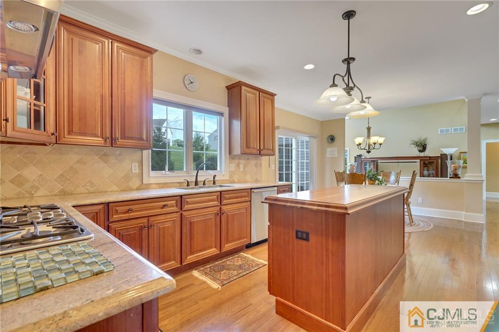 21 Rolin's Mill Road Flemington, NJ 08822 - Photo 13 of 25 a kitchen with stainless steel appliances granite countertop a stove a sink dishwasher and wooden cabinets with wooden floor