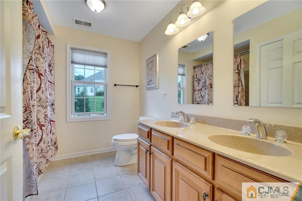 21 Rolin's Mill Road Flemington, NJ 08822 - Photo 16 of 25 a bathroom with a granite countertop sink a toilet a mirror a vanity and window
