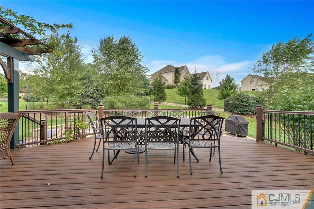 21 Rolin's Mill Road Flemington, NJ 08822 - Photo 23 of 25 a view of a roof deck with table and chairs a barbeque with wooden floor and fence