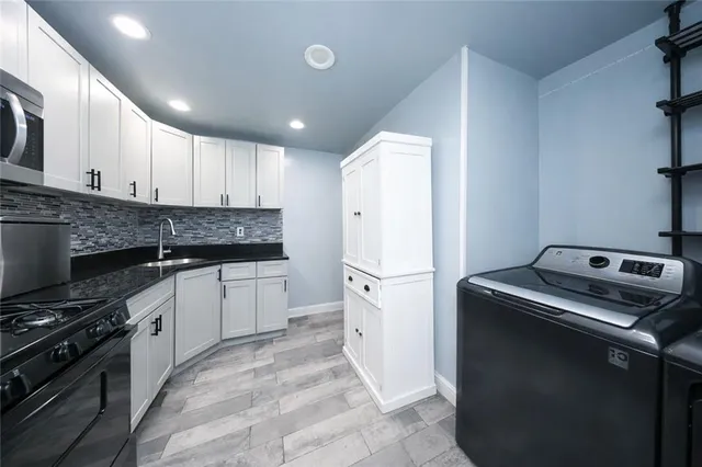 a kitchen with a refrigerator and a stove top oven