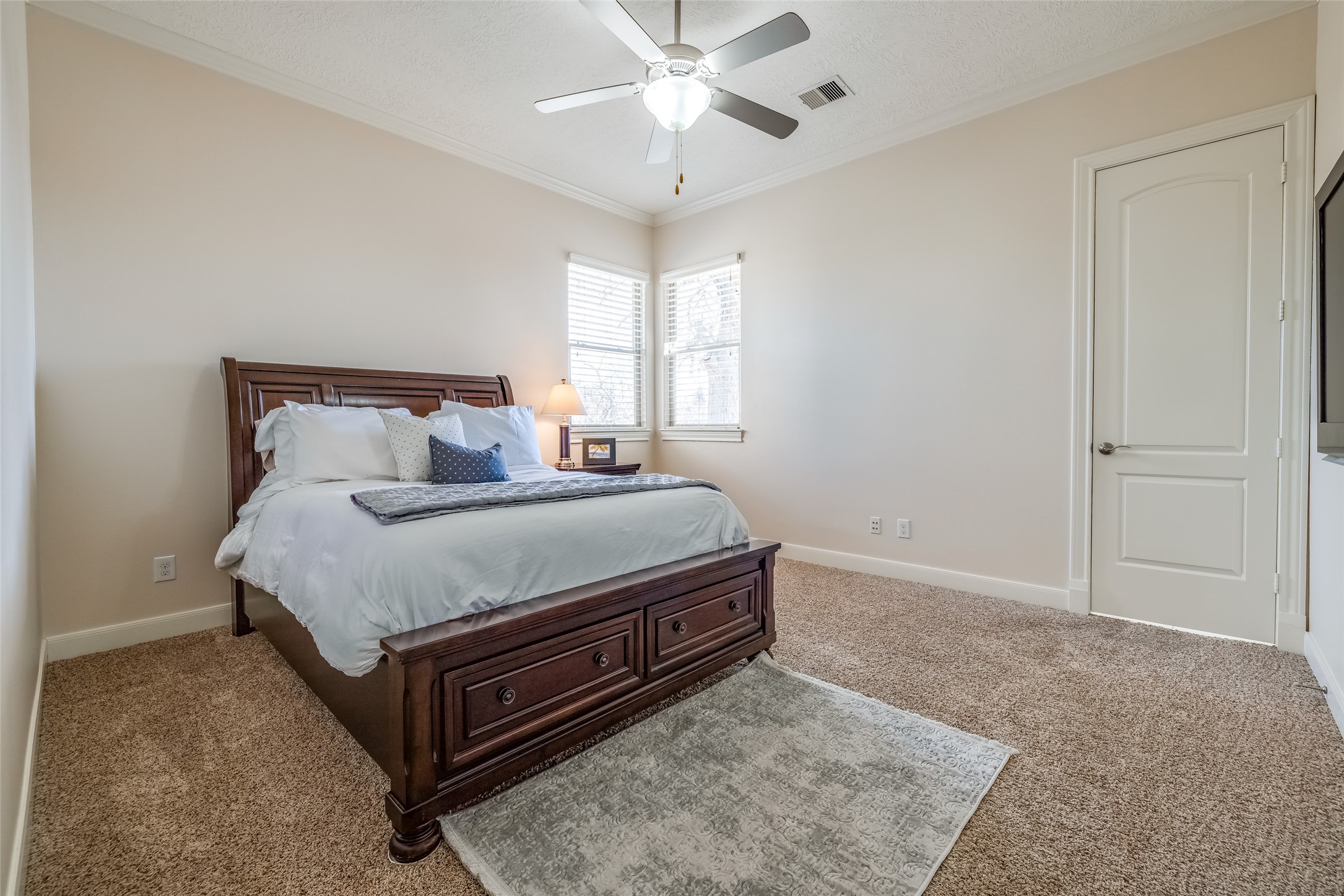 31102 Lower Oxbow Trace Fulshear, TX 77441 - Photo 26 of 50 Bedroom 2 with en suite bathroom, carpet, ceiling fan, closet