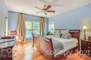 1409 Riverside Drive Charlotte, NC 28214 - Photo 12 of 23 a bedroom with a large bed and a large window