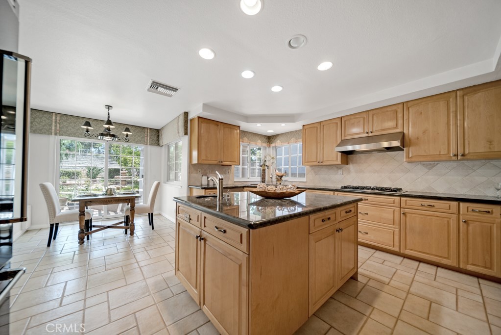 18845 Beechtree Lane Porter Ranch, CA 91326 - Photo 11 of 41 a kitchen with granite countertop a sink stove and cabinets