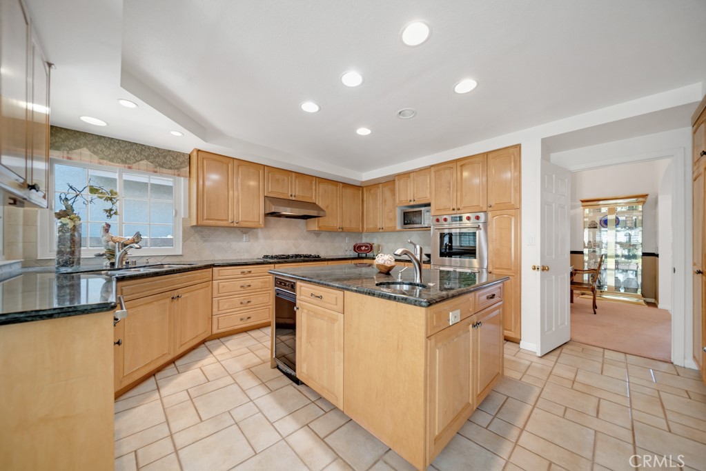18845 Beechtree Lane Porter Ranch, CA 91326 - Photo 12 of 41 a kitchen with stainless steel appliances granite countertop a refrigerator and a stove top oven