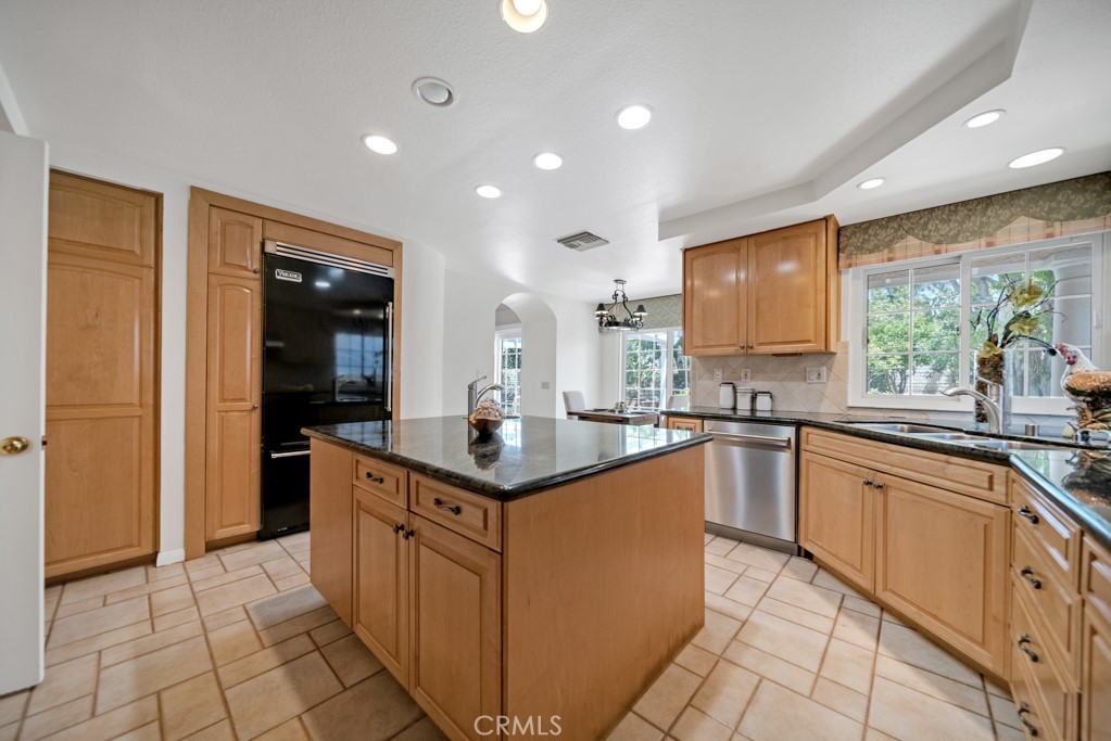 18845 Beechtree Lane Porter Ranch, CA 91326 - Photo 13 of 41 a kitchen with stainless steel appliances granite countertop a sink and cabinets