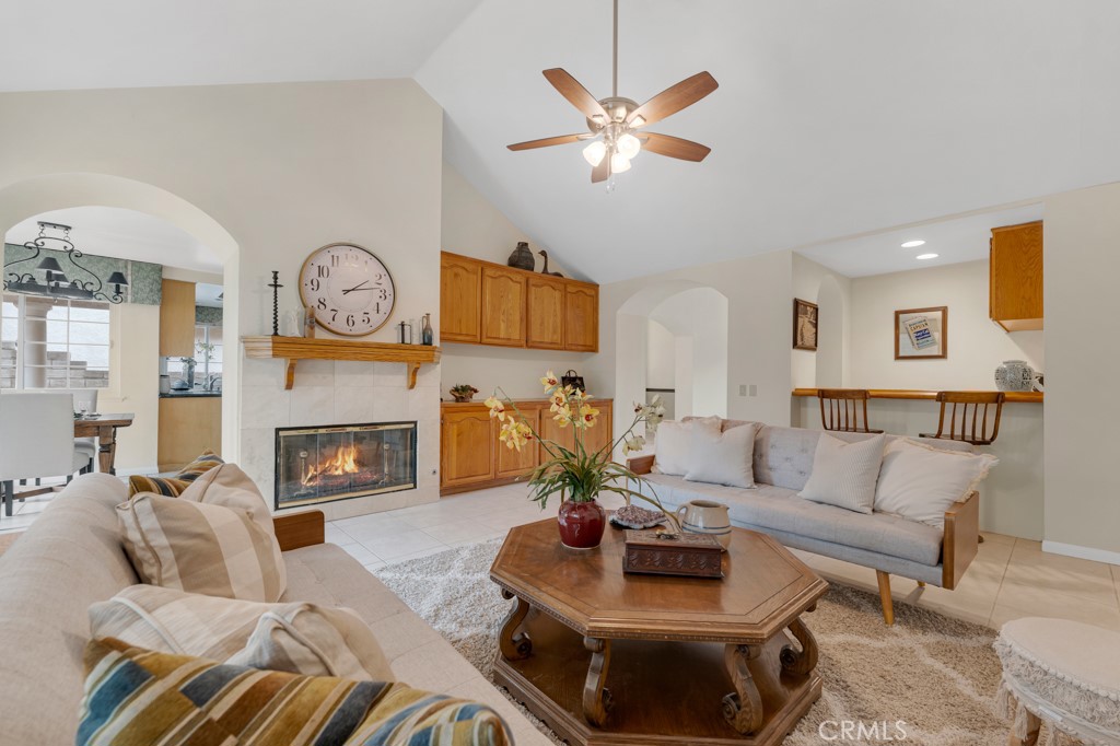 18845 Beechtree Lane Porter Ranch, CA 91326 - Photo 15 of 41 a living room with furniture a clock and a fireplace