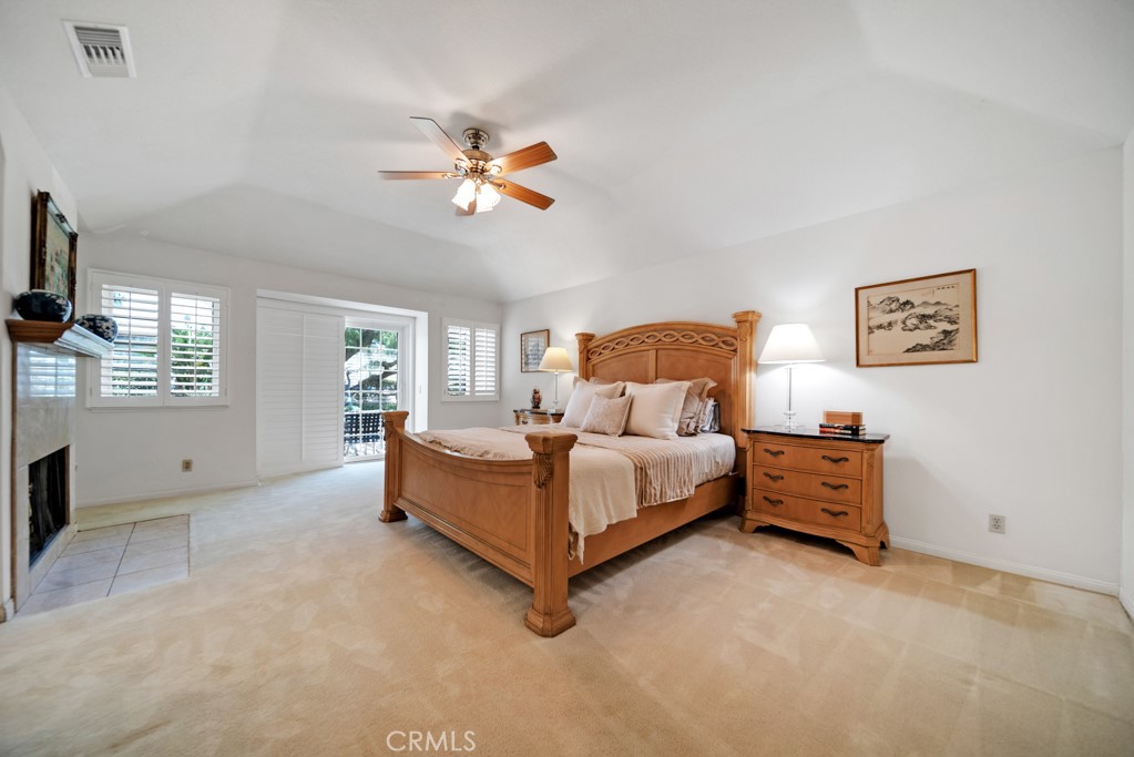 18845 Beechtree Lane Porter Ranch, CA 91326 - Photo 19 of 41 a bed room with a bed and a chandelier