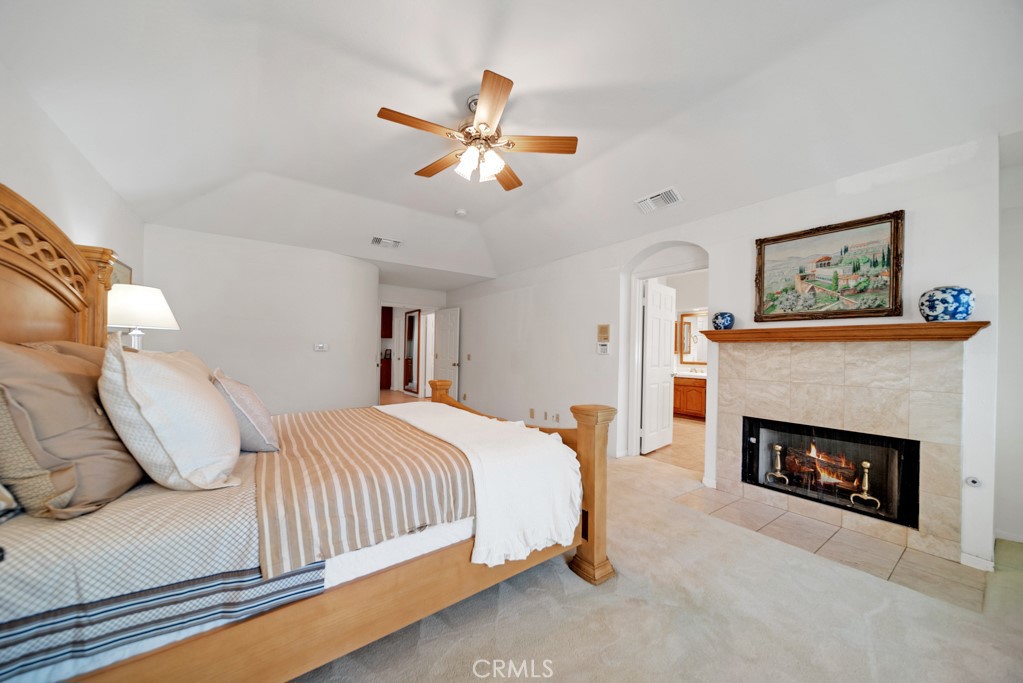 18845 Beechtree Lane Porter Ranch, CA 91326 - Photo 20 of 41 a bedroom with a bed and a fireplace