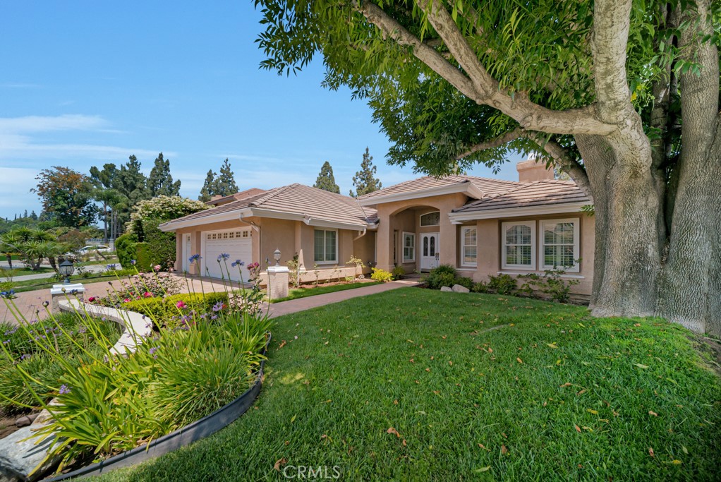 18845 Beechtree Lane Porter Ranch, CA 91326 - Photo 2 of 41 a front view of a house with garden