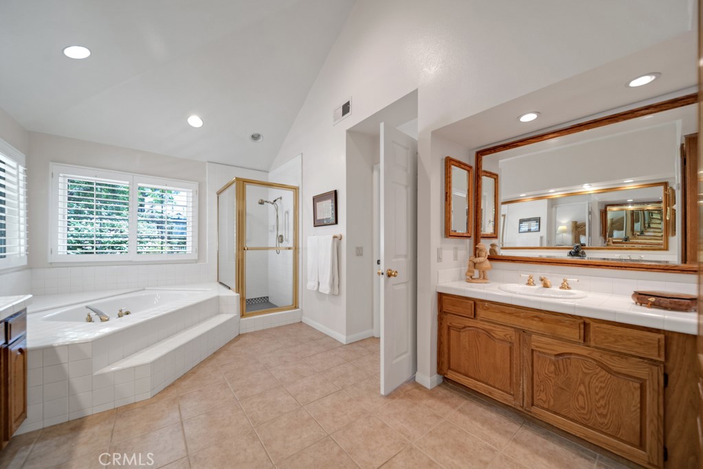 18845 Beechtree Lane Porter Ranch, CA 91326 - Photo 22 of 41 a spacious bathroom with a tub sink and mirror