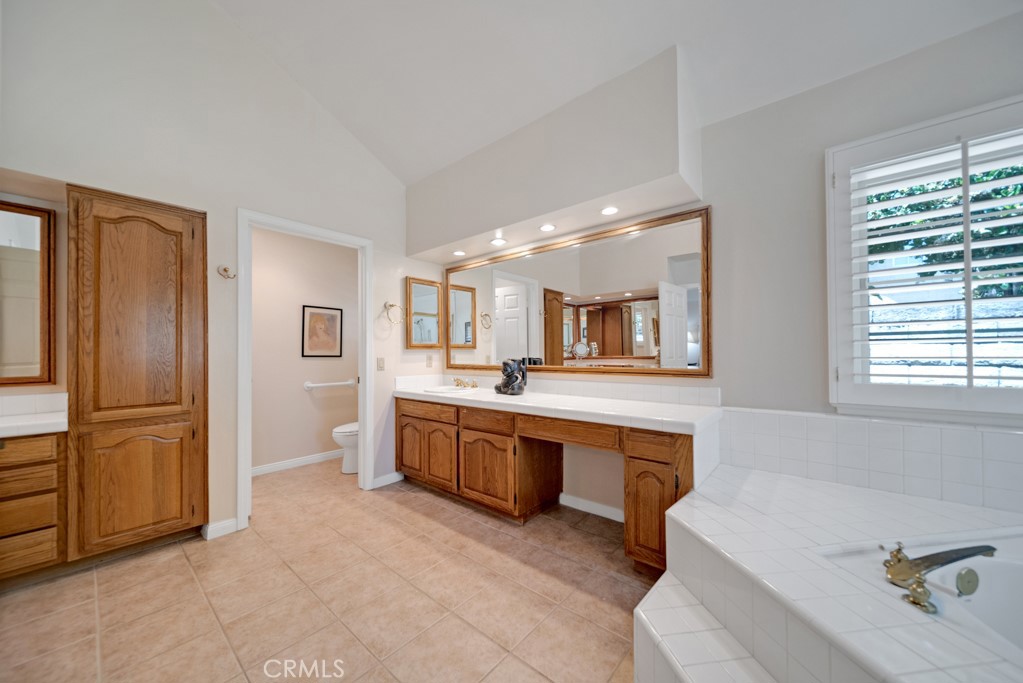 18845 Beechtree Lane Porter Ranch, CA 91326 - Photo 23 of 41 a large white kitchen with cabinets