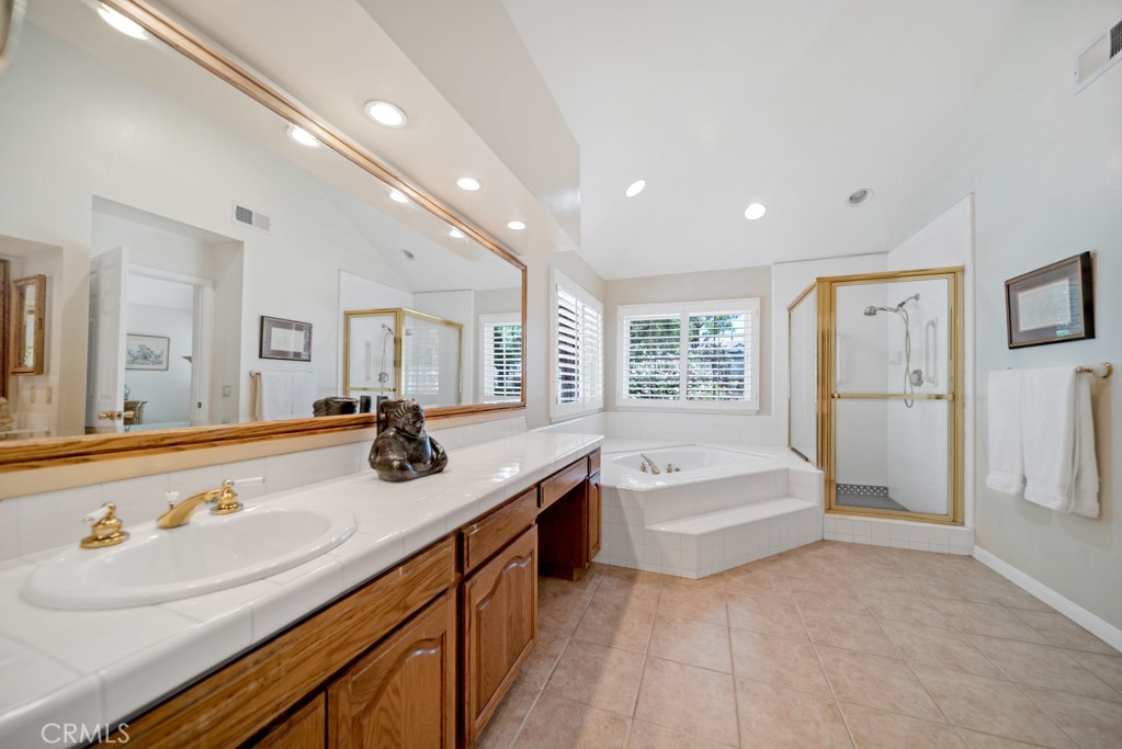 18845 Beechtree Lane Porter Ranch, CA 91326 - Photo 24 of 41 a spacious bathroom with a tub sink and mirror