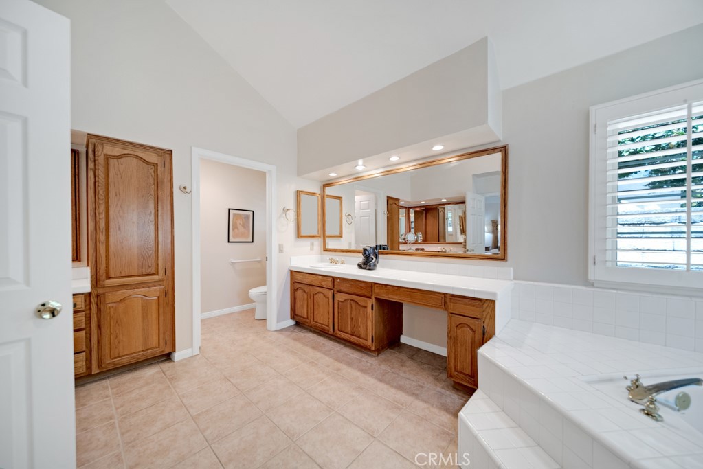18845 Beechtree Lane Porter Ranch, CA 91326 - Photo 25 of 41 a large bathroom with a tub sink and mirror