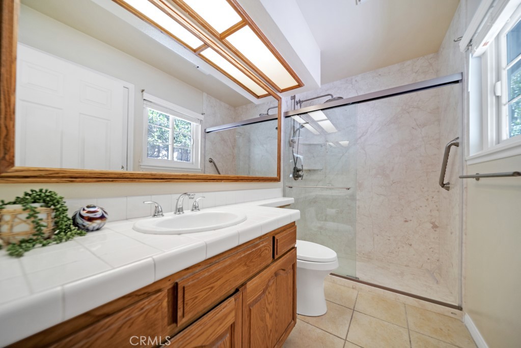 18845 Beechtree Lane Porter Ranch, CA 91326 - Photo 27 of 41 a bathroom with a sink and a mirror
