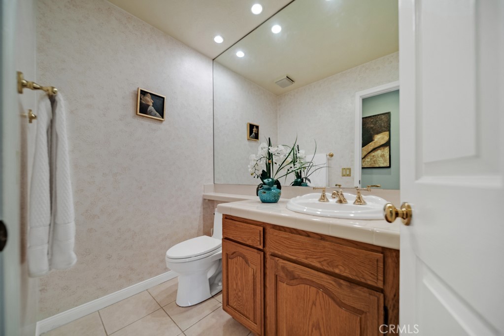 18845 Beechtree Lane Porter Ranch, CA 91326 - Photo 34 of 41 a bathroom with a toilet sink and mirror