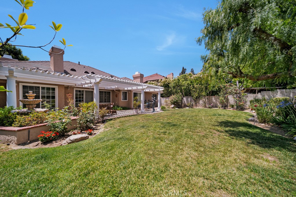 18845 Beechtree Lane Porter Ranch, CA 91326 - Photo 36 of 41 a front view of house with a garden