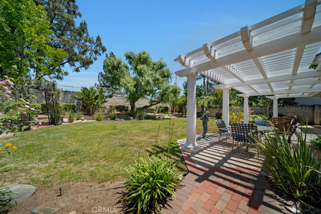 18845 Beechtree Lane Porter Ranch, CA 91326 - Photo 37 of 41 a view of a patio with table and chairs potted plants and large tree