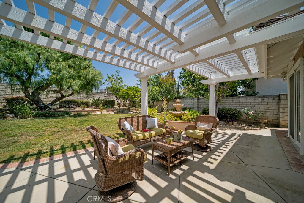 18845 Beechtree Lane Porter Ranch, CA 91326 - Photo 39 of 41 a view of a patio with table and chairs potted plants and water view