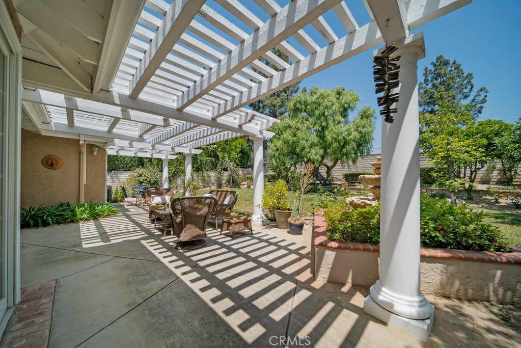 18845 Beechtree Lane Porter Ranch, CA 91326 - Photo 40 of 41 a view of a patio with table and chairs potted plants with wooden floor and plants