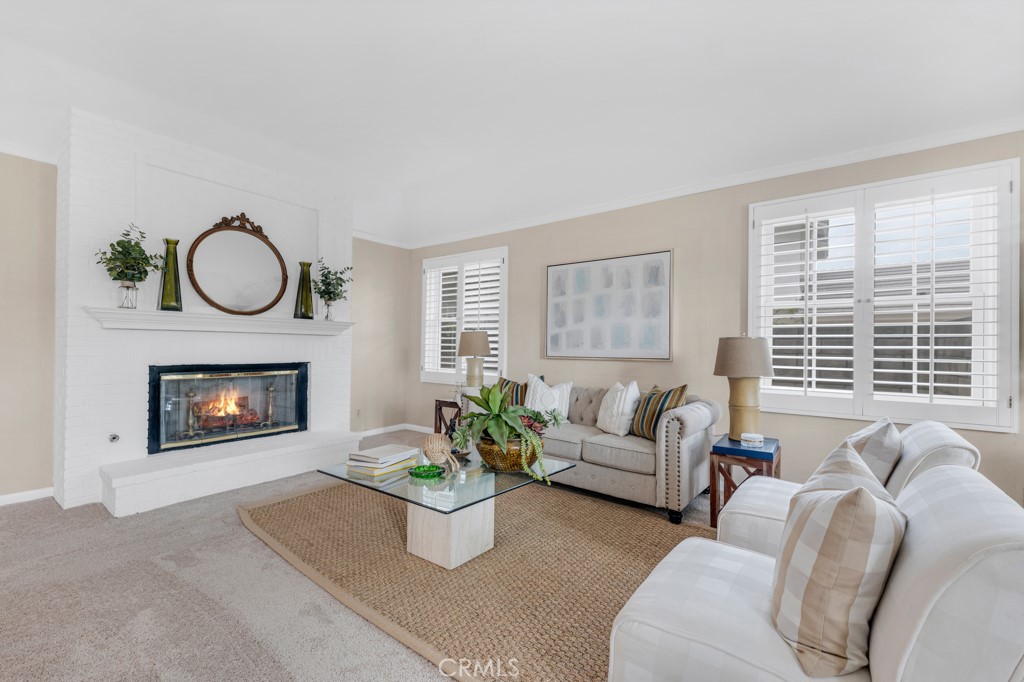 18845 Beechtree Lane Porter Ranch, CA 91326 - Photo 8 of 41 a living room with furniture a fireplace and a large window