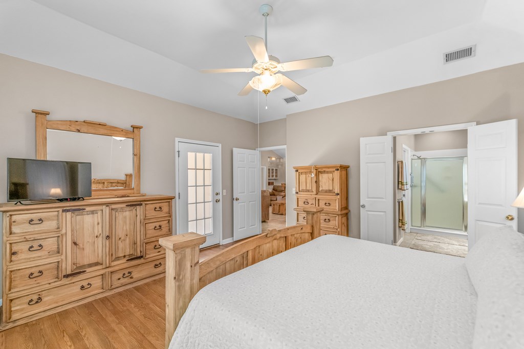 225 Los Cedros Loop Kerrville, TX 78028 - Photo 9 of 27 a bedroom with a bed and a flat screen tv