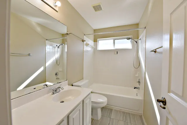 a bathroom with a sink toilet tub and shower