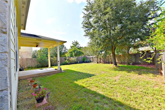a view of a house with a big yard and potted plants