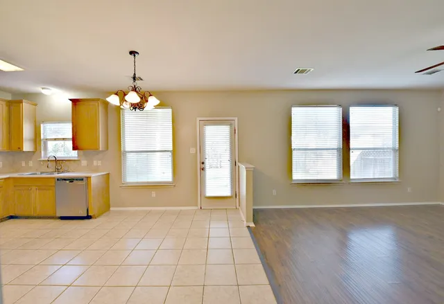 a view of a kitchen with a sink and chandelier