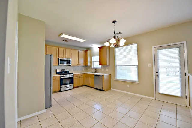 a kitchen with a refrigerator and a sink