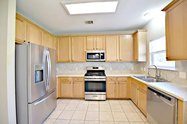 a kitchen with a stove a sink and a refrigerator