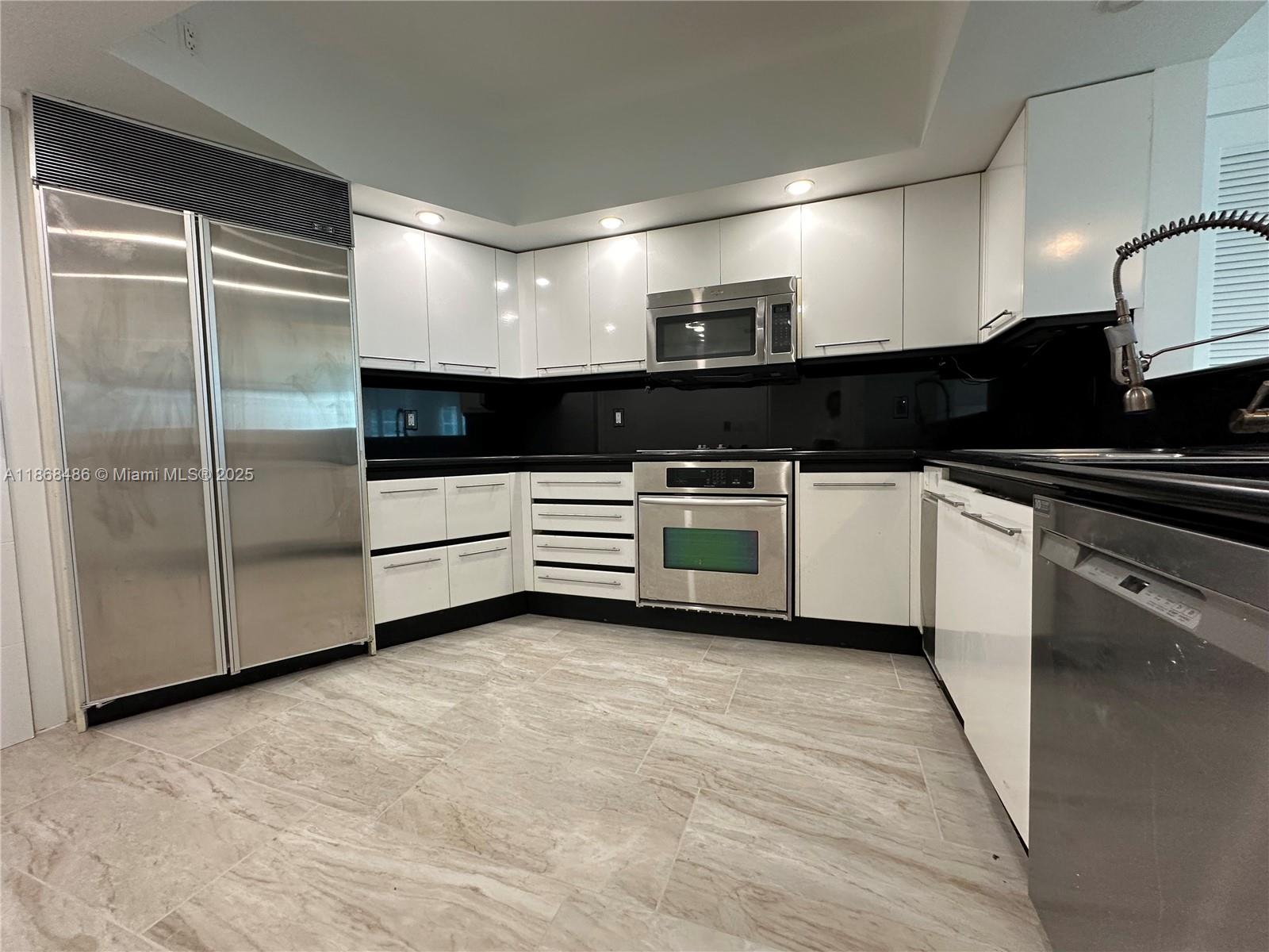 2127 Brickell Avenue, Unit 1504 Miami, FL 33129 - Photo 15 of 44 a kitchen with stainless steel appliances a refrigerator a sink a stove and cabinets
